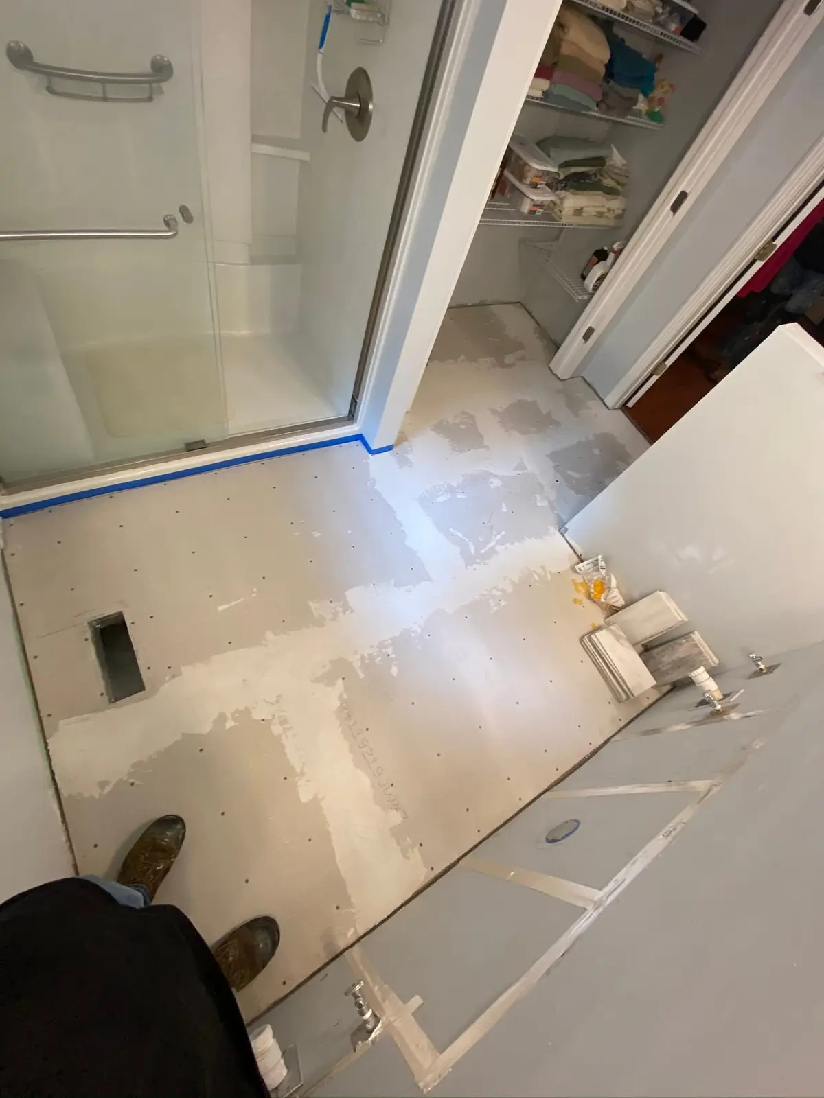 During work — Marble-Look Tile Floor with Walk-In Shower