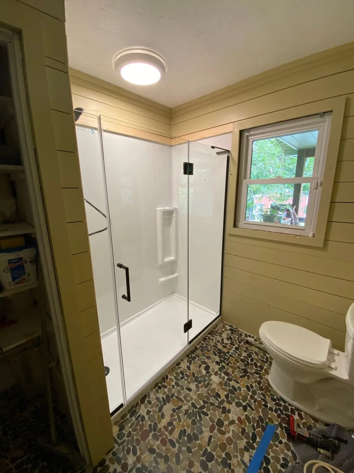 Shiplap Bath with Glass Shower and Pebble Floor