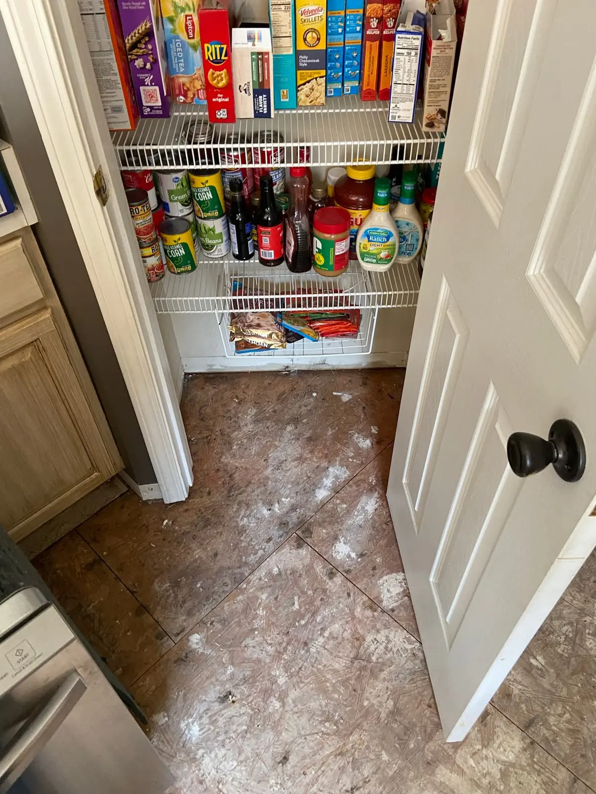 Pantry and laundry bare subfloor during flooring preparation