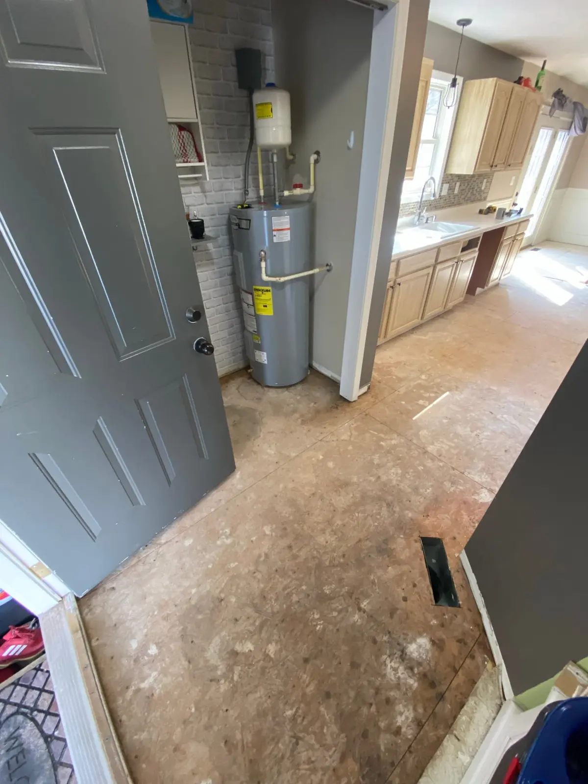 Pantry and laundry bare subfloor during flooring preparation
