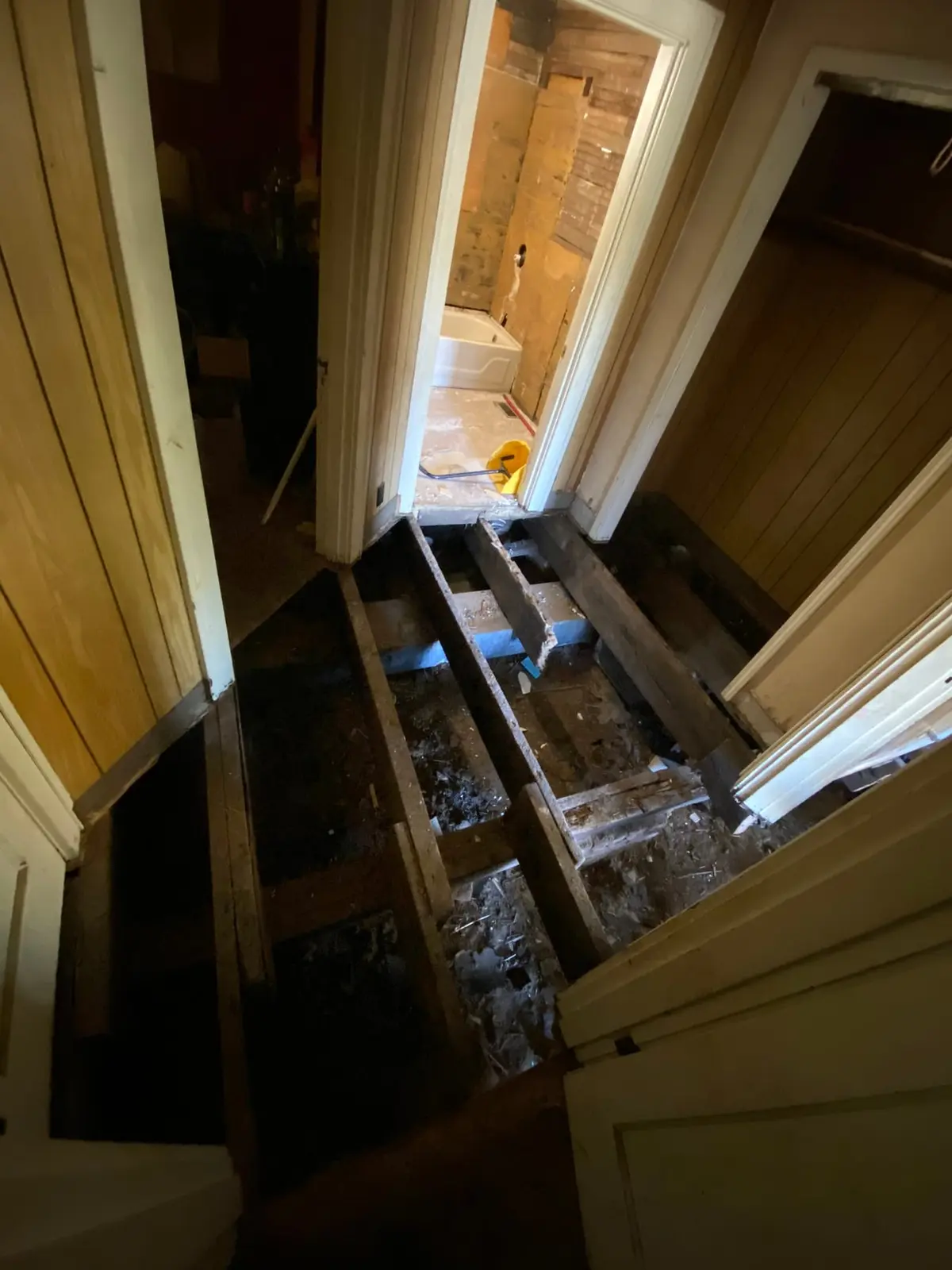 Floor Joist Rebuild in Wood-Paneled House