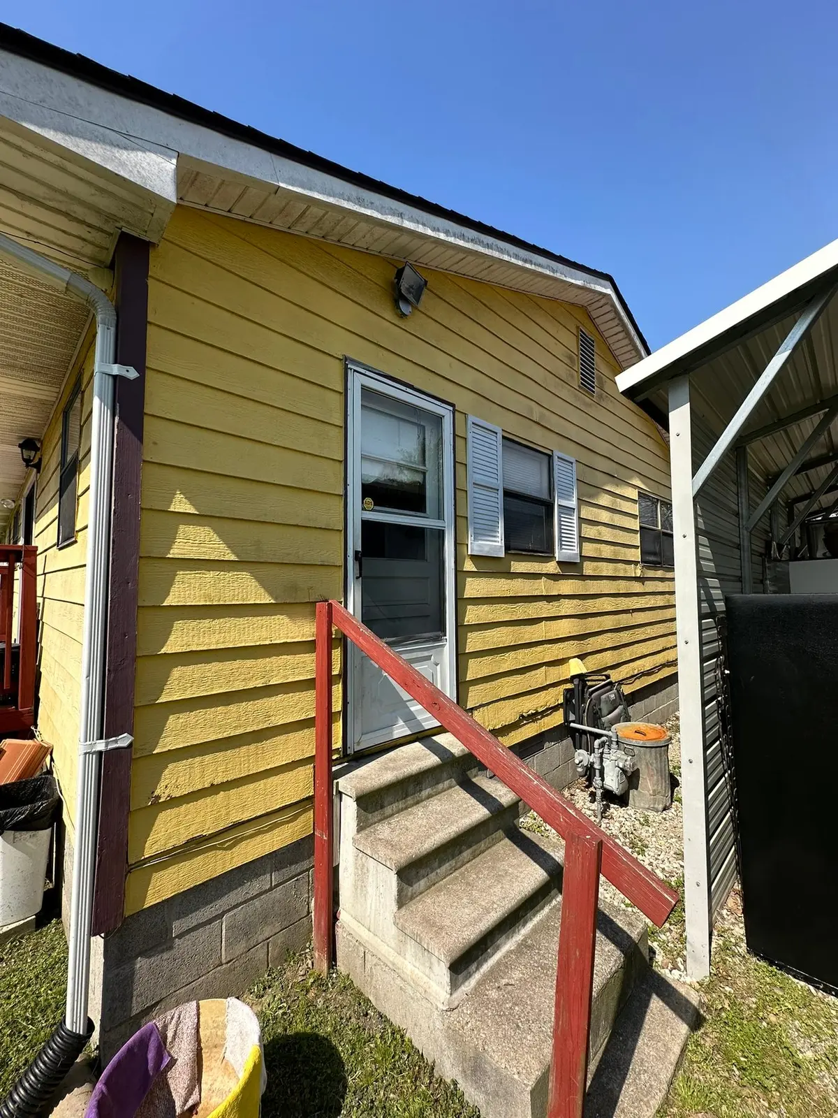 Yellow Ranch House Re-Sided in Navy Blue — Before photo 1