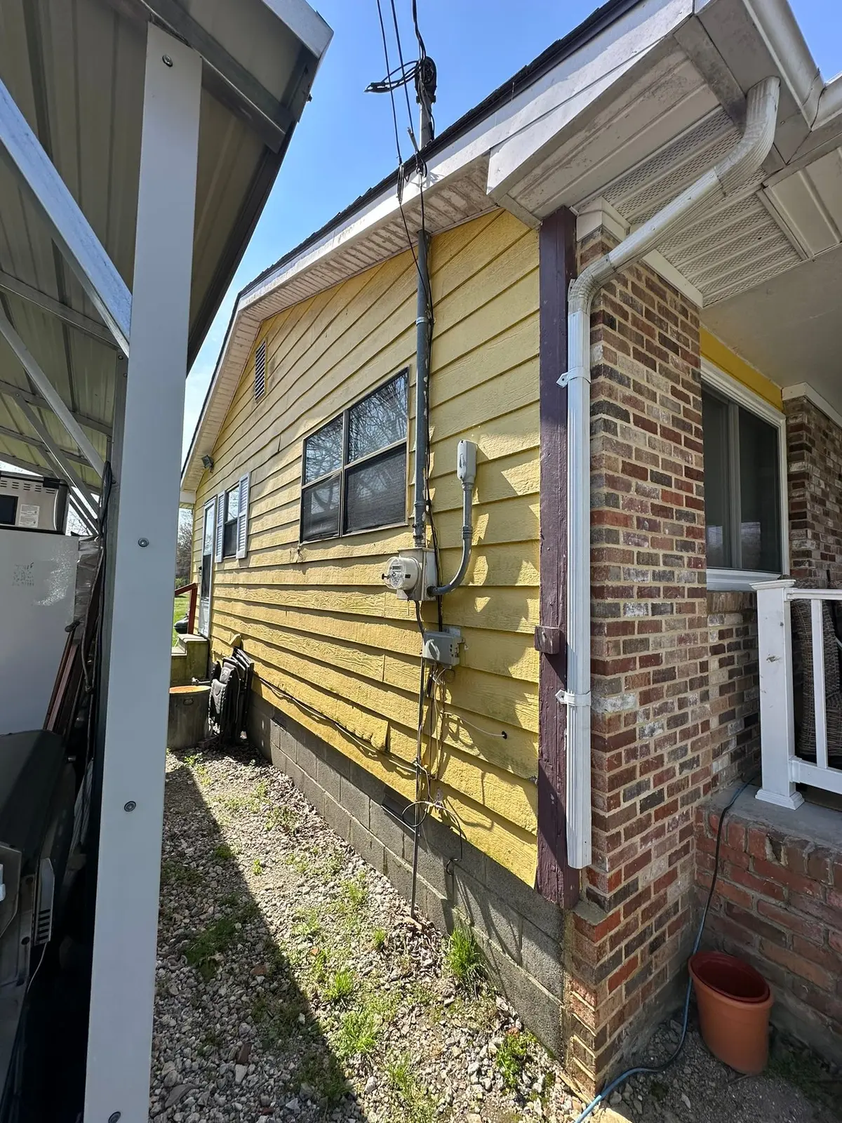 Yellow Ranch House Re-Sided in Navy Blue — Before photo 2