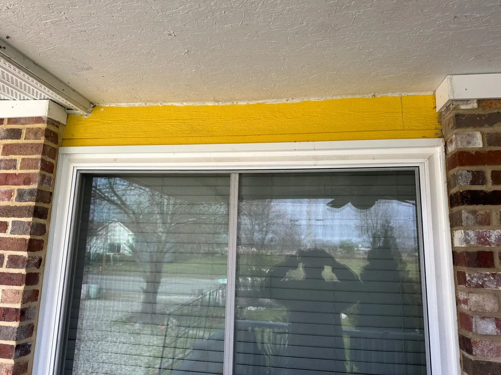 Yellow Ranch House Re-Sided in Navy Blue — Before photo 4