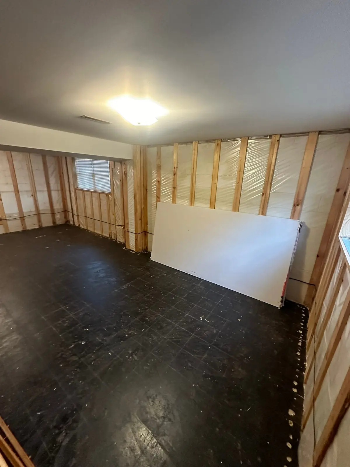 During work — Lower-Level Remodel, Paneling to Drywall with New Floor