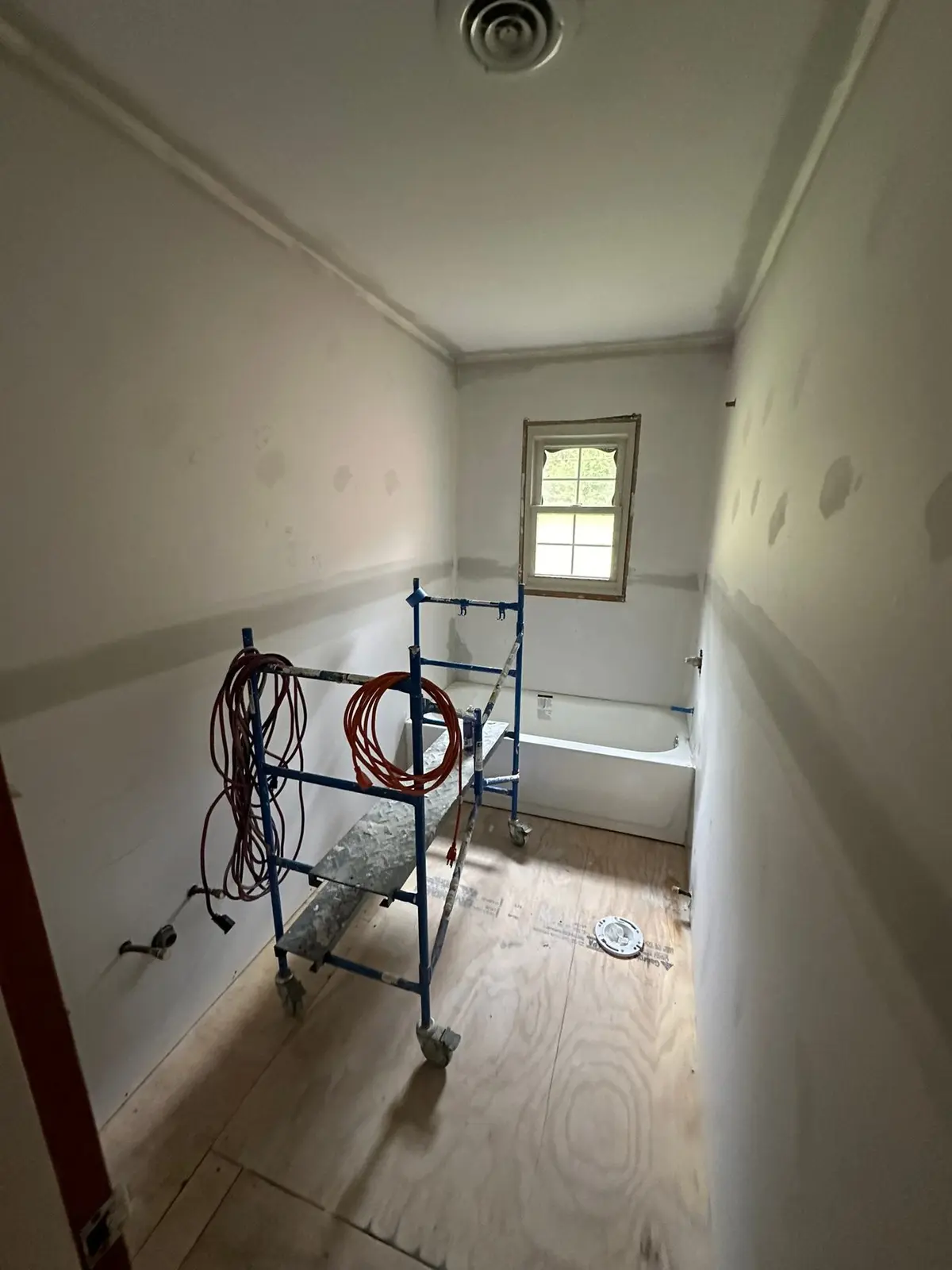 During work — Long Bathroom with New Gray Plank Floor