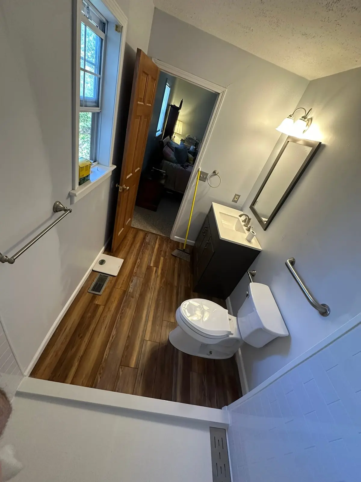 Bathroom with Grab Bars and Plank Floor — finished photo 3