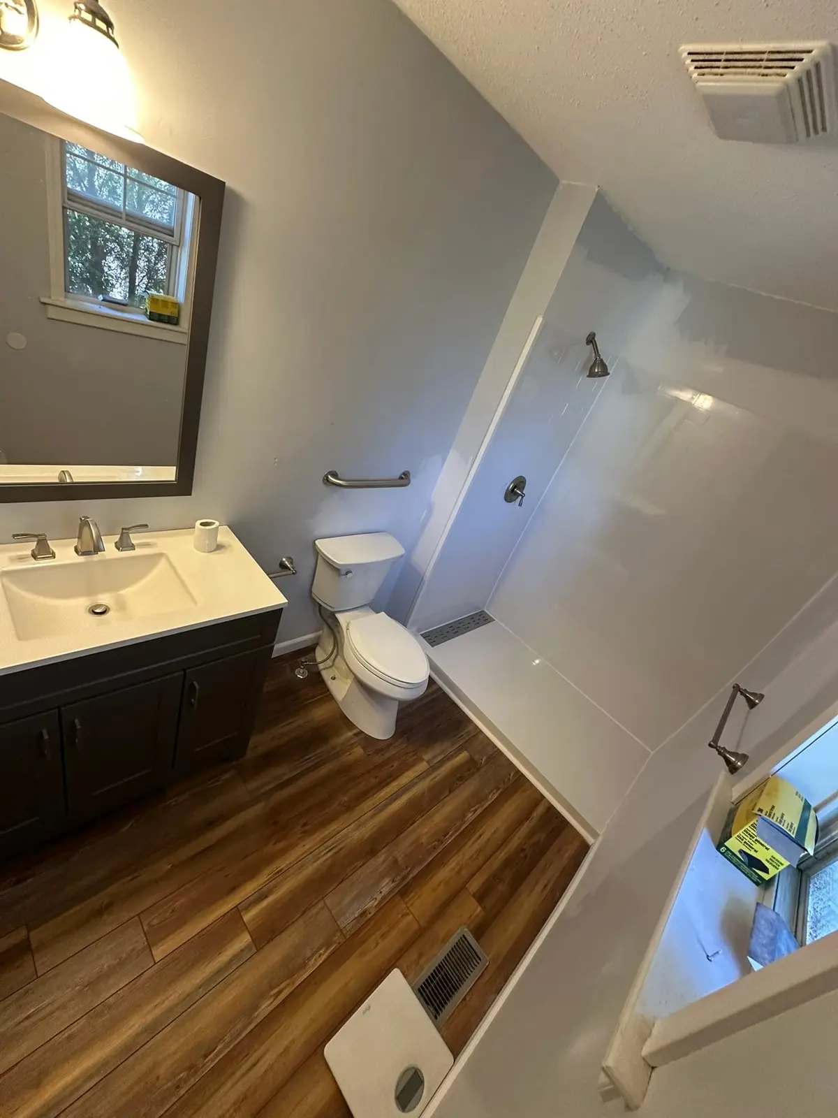 Bathroom with Grab Bars and Plank Floor
